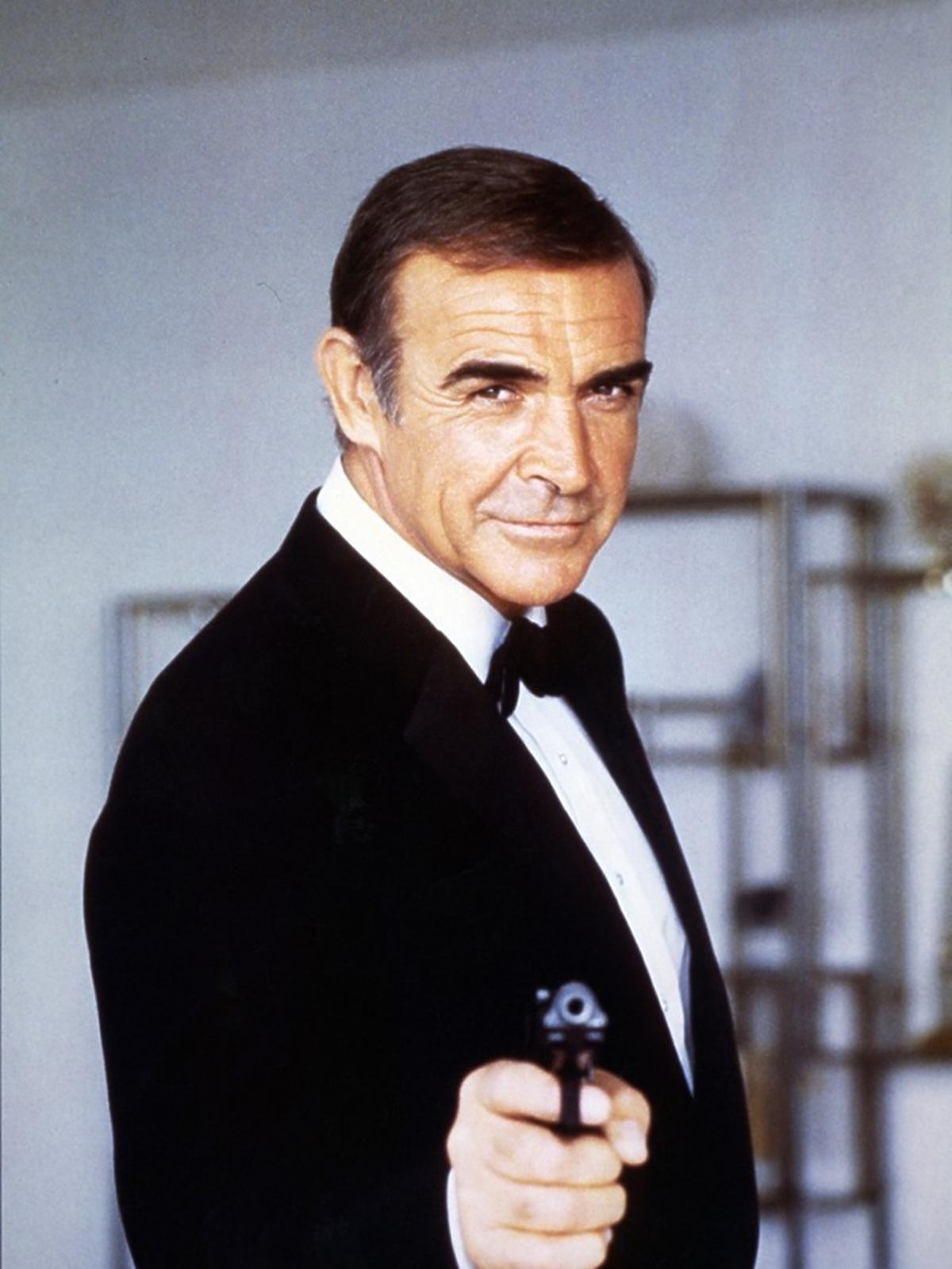 Sean Connery celuje z pistoletu, w czarnej muszce
