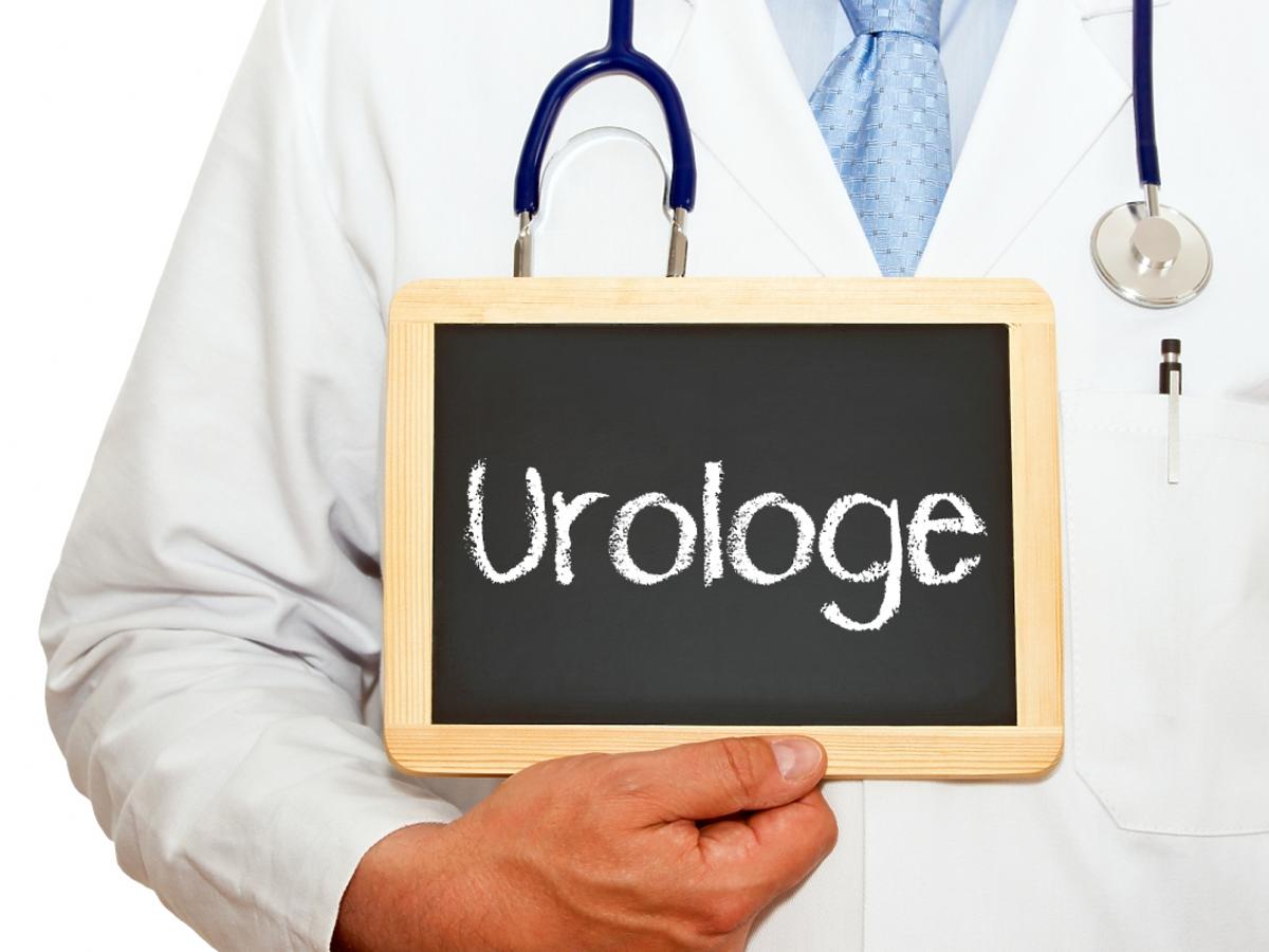 lekarz trzyma tabliczkę z napisem "urologie"