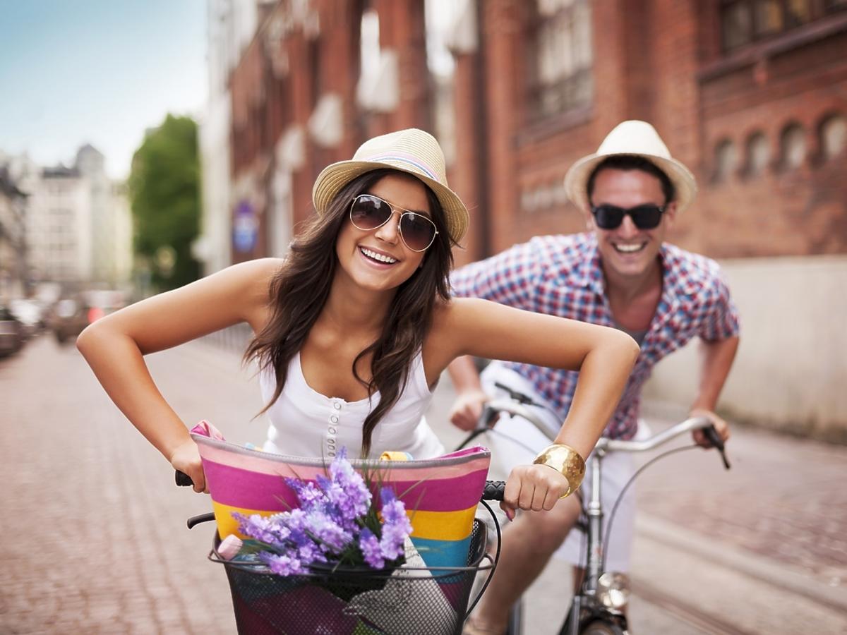 Para przyjaciół jeździ rowerami po mieście.